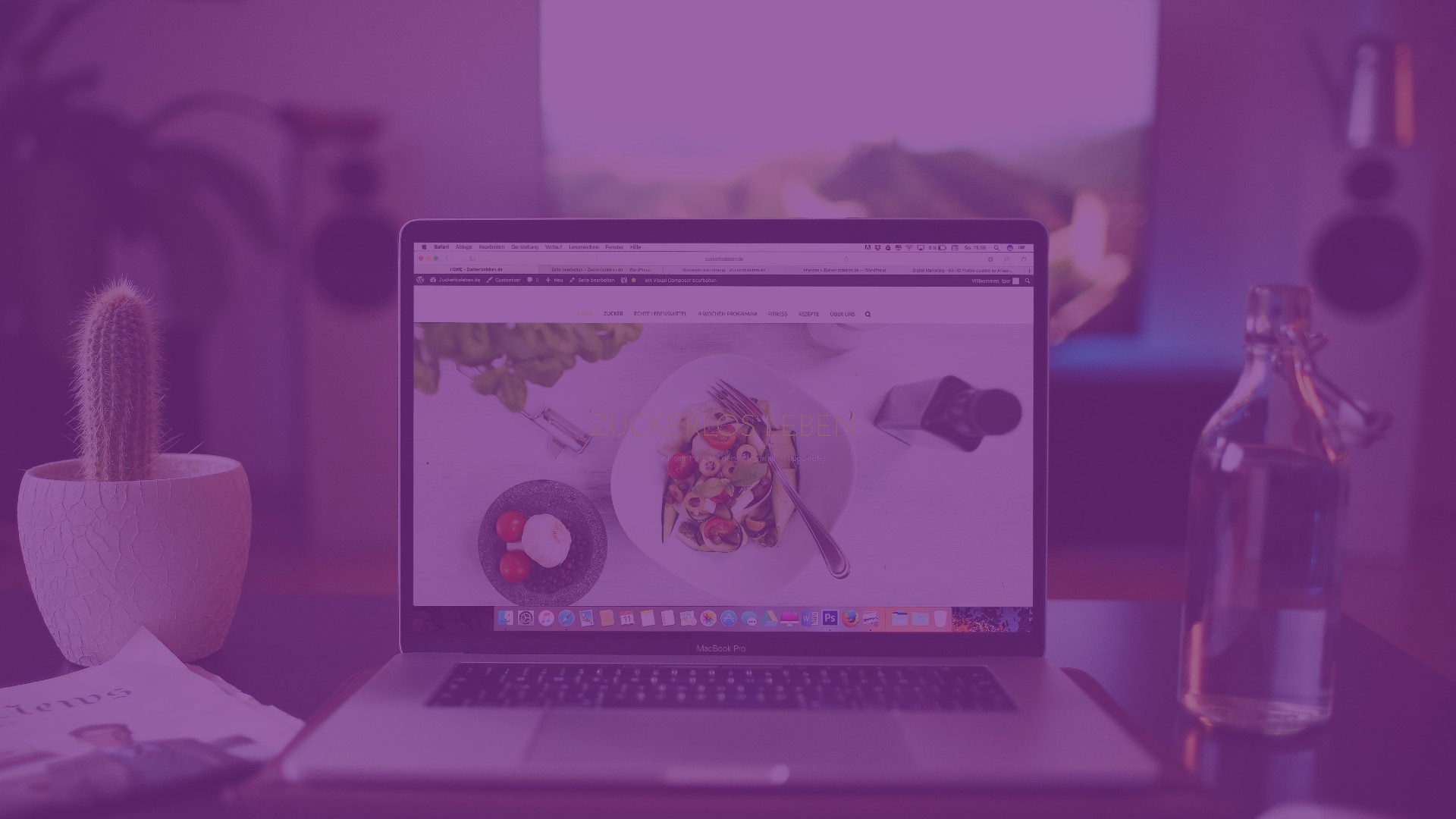 Macbook on a table with website showing colourful salad
