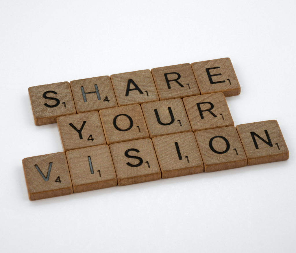 Scrabble letters spelling out SHARE YOUR VISION